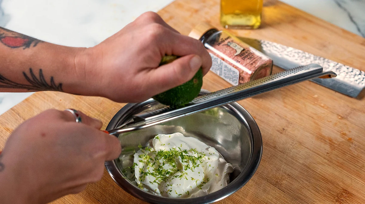 Lime zest grated over sour cream to make lime crema, with The Salted Roots Prickly Chipotle Salt on the board
